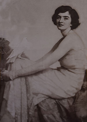 Portrait of Hazel ffennell seated with a dove on her knee, by Harold Speed